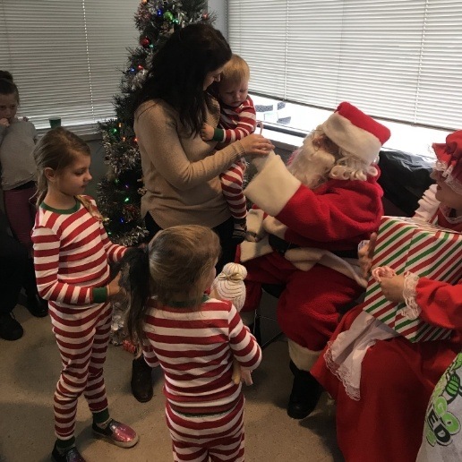 Hammond dentist dressed as Santa Claus giving candy canes to children