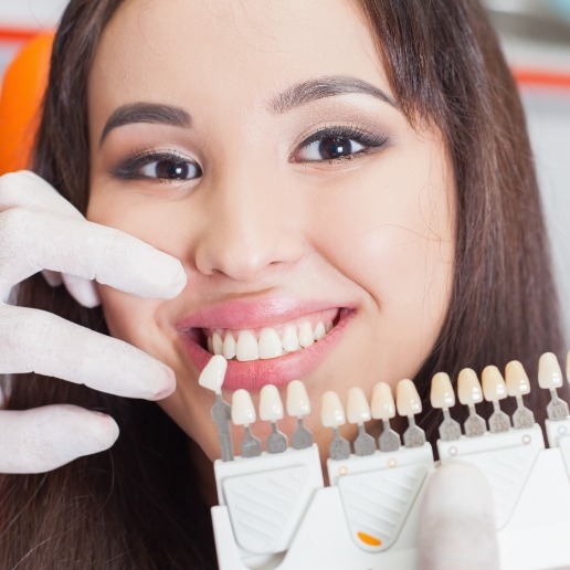 Young woman trying on dental veneers from her cosmetic dentist in Hammond