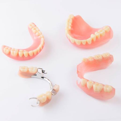 Full and partial dentures pictured against white background