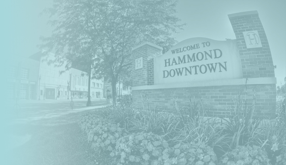 Brick sign in city garden reading Welcome to Hammond Downtown