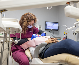 Dental patient having their teeth professionally cleaned by dental hygienist in Hammond