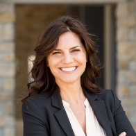 Smiling businesswoman standing with arms crossed