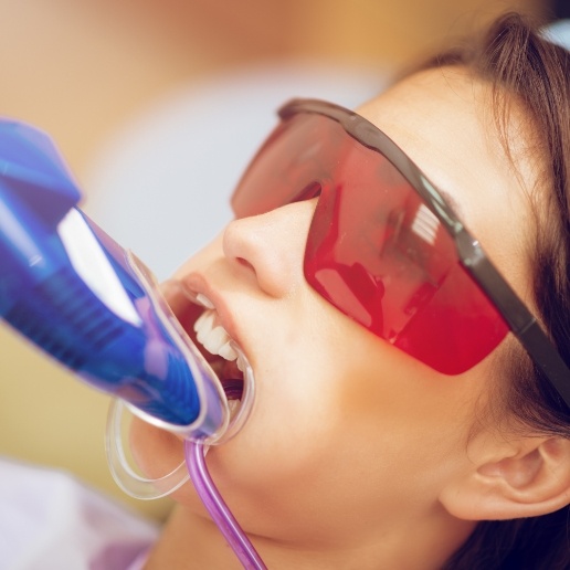 Young girl receiving fluoride treatment in dental office